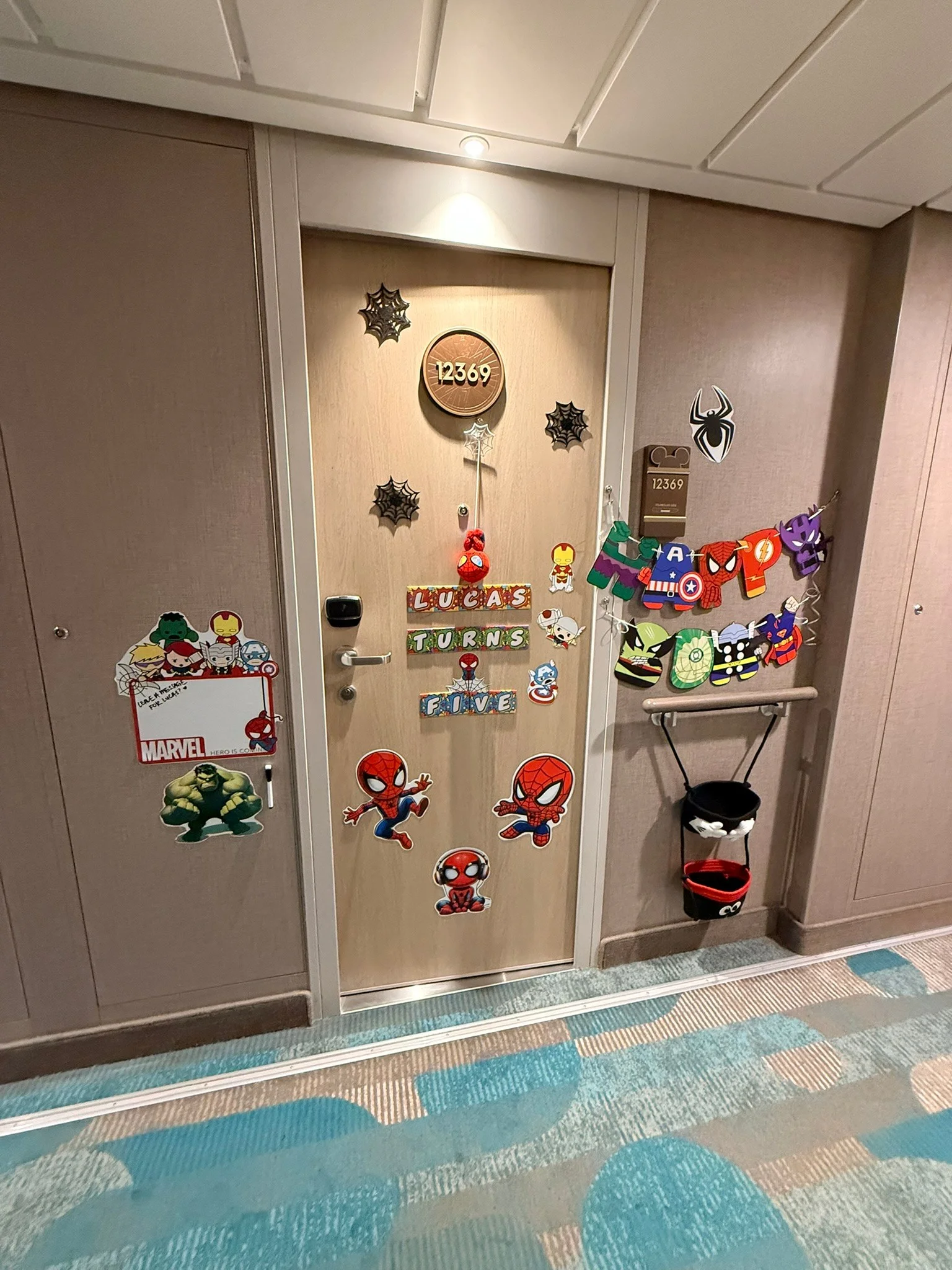 Our stateroom door decorated with Marvel characters and “Lucas Turns Five” magnets.