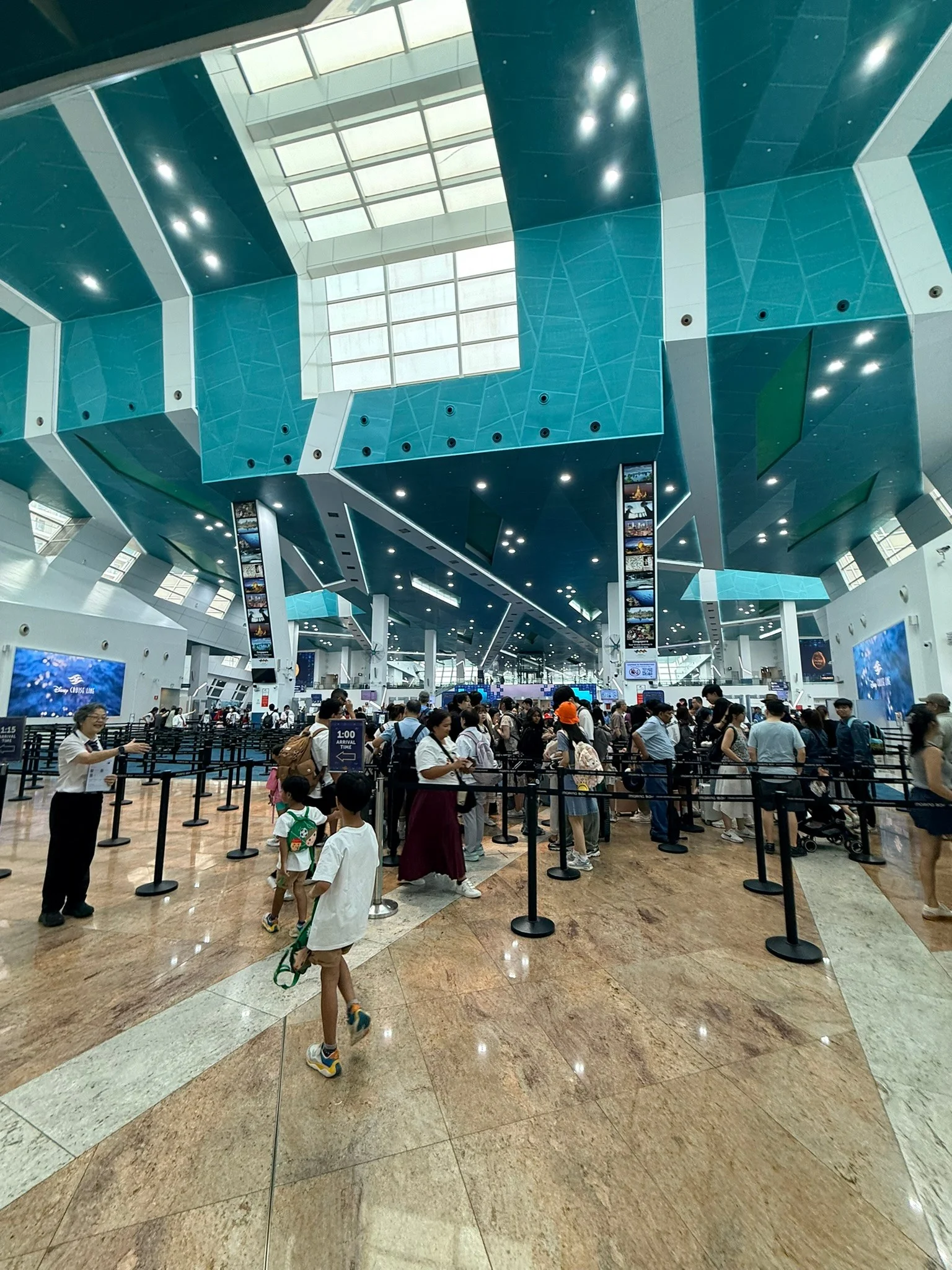 The busy check-in hall at the cruise terminal on boarding day.