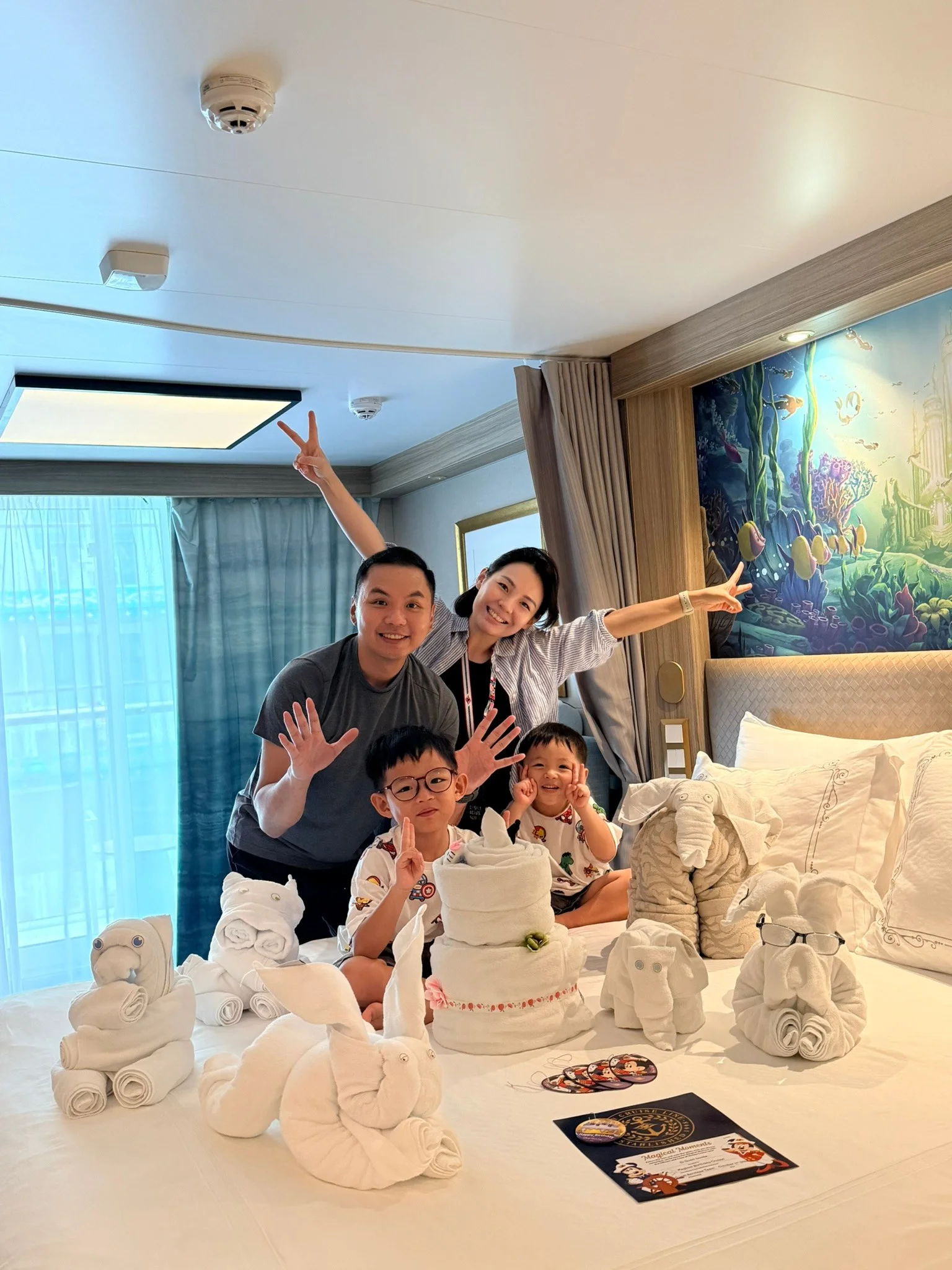 The four of us on the bed with the birthday towel animals.