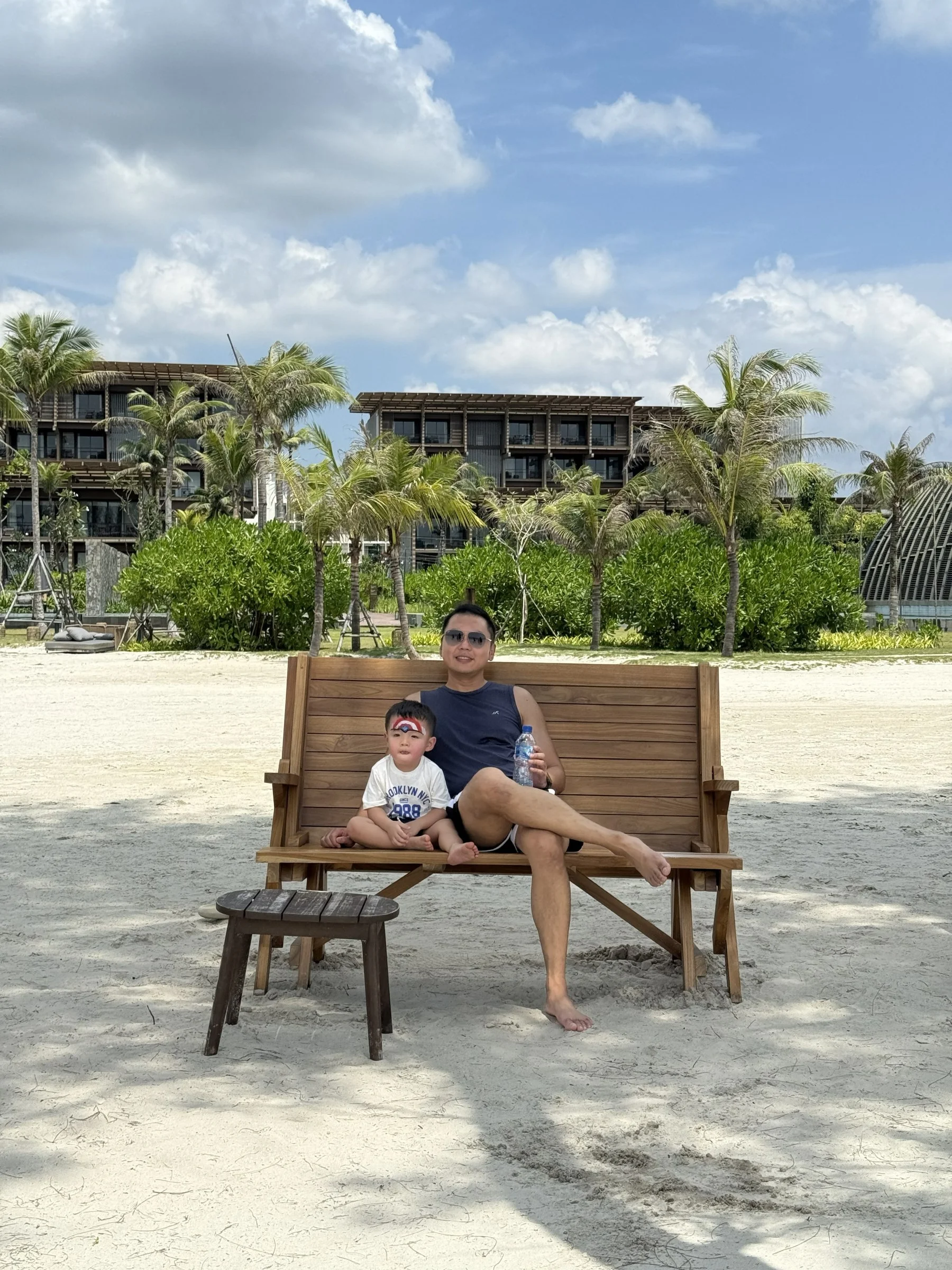 A quiet family moment relaxing on a wooden beach chair at the resort.