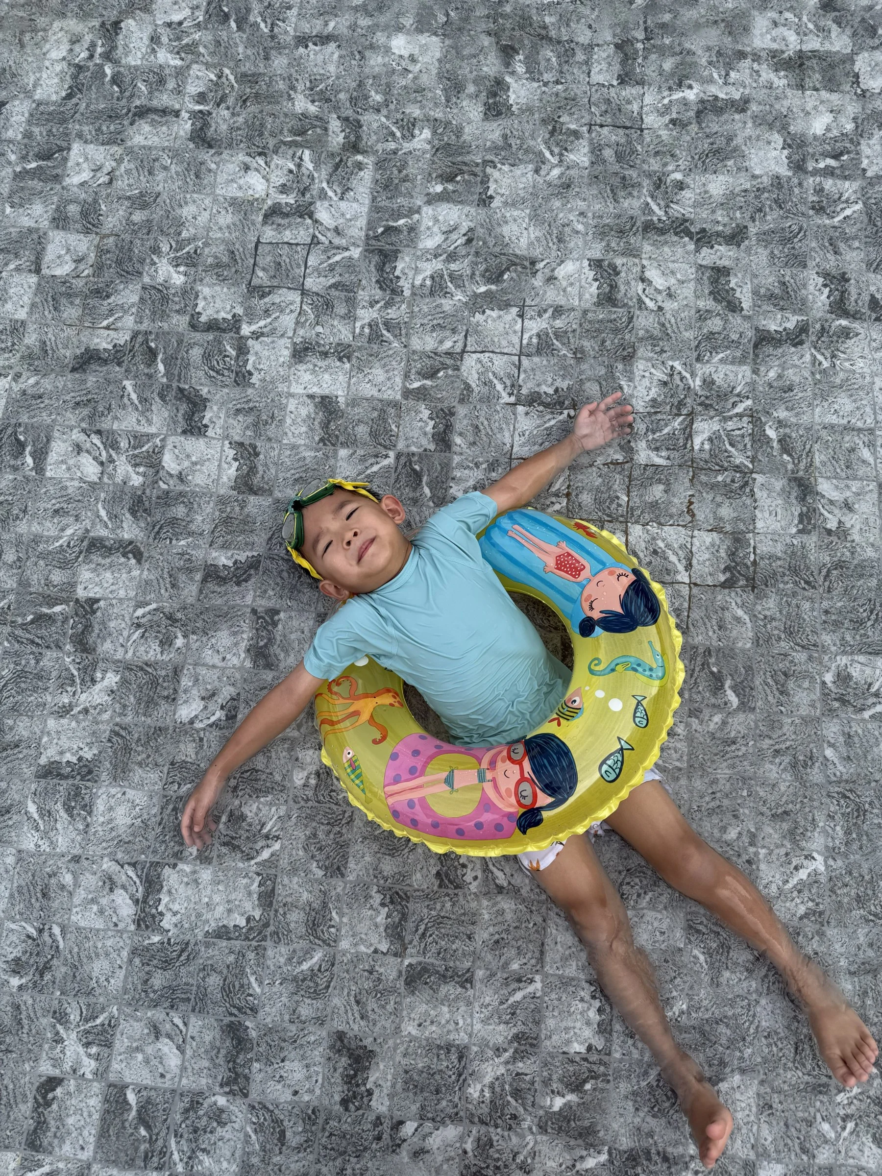 Lucas relaxing in a colourful swim ring